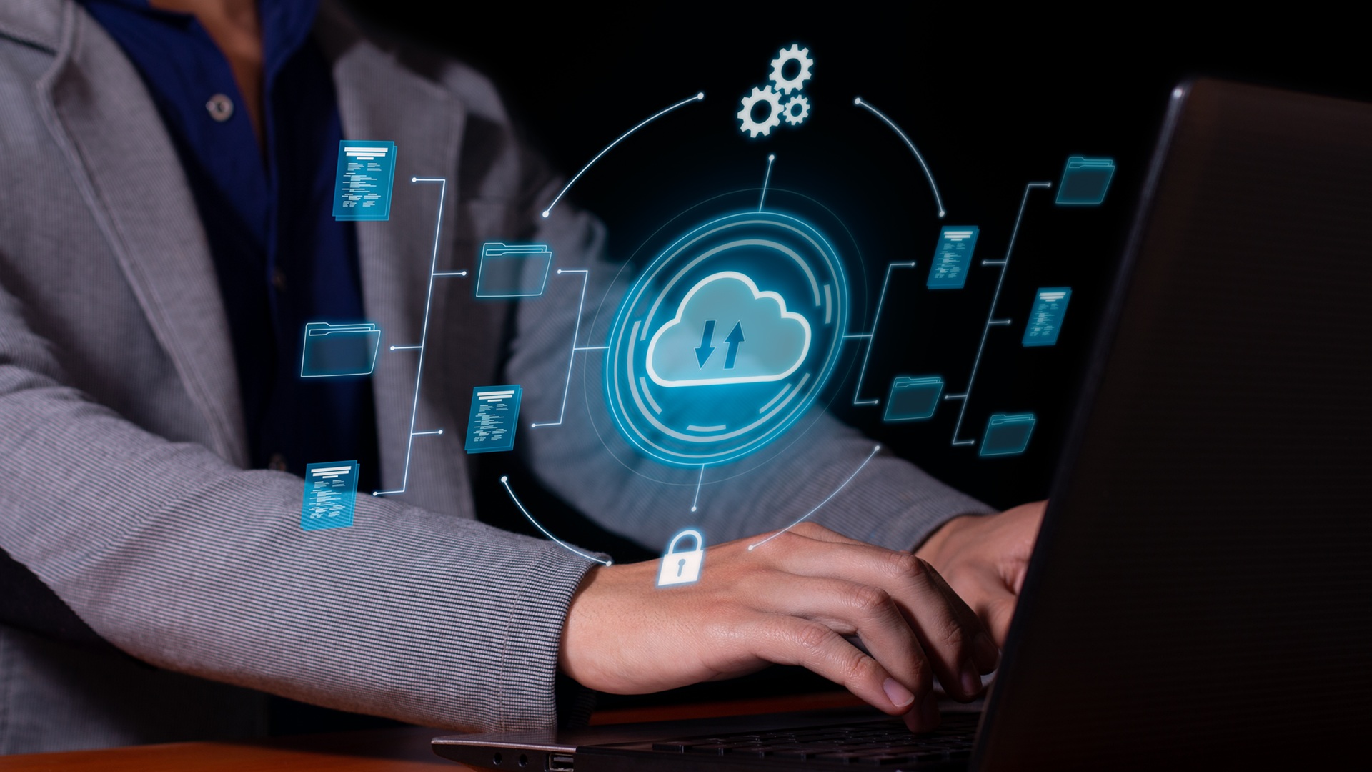 Man uses cloud computing on his computer to transmit, store and backup important data and information.